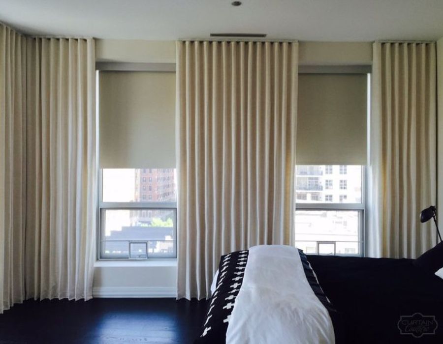 Light beige panel drapes in a modern bedroom